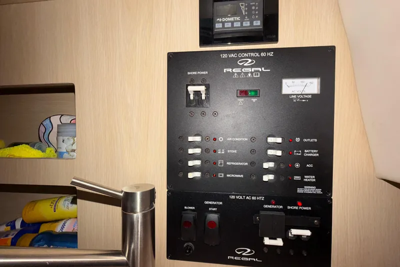 Slide: The Image of Electrical control panel of 2023 Regal 26 XO boat, featuring various switches and gauges. - 128