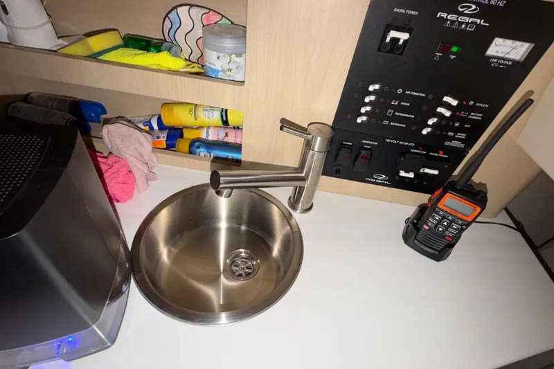 Slide: The Image of 2023 Regal 26 XO boat interior with sink, control panel, and radio. - 129