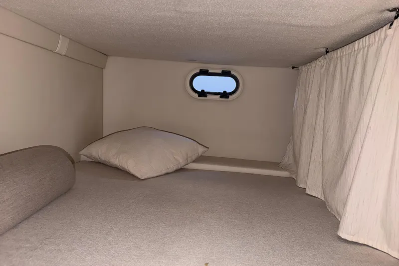 Slide: The Image of Cozy cabin interior of 2023 Regal 26 XO boat with window and curtains. - 130