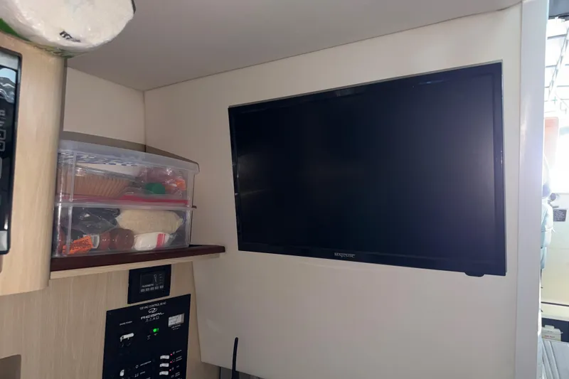 Slide: The Image of Interior of 2023 Regal 26 XO boat with TV and storage shelves. - 131