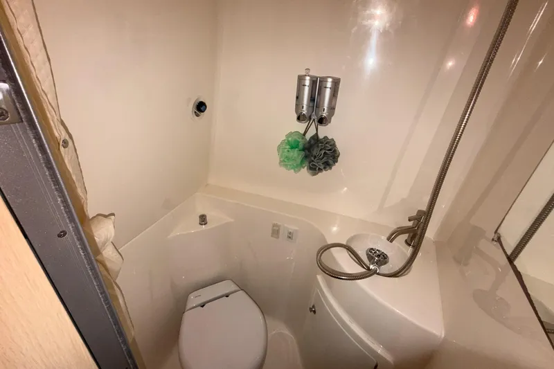 Slide: The Image of Compact bathroom in 2023 Regal 26 XO boat with toilet and shower amenities. - 137