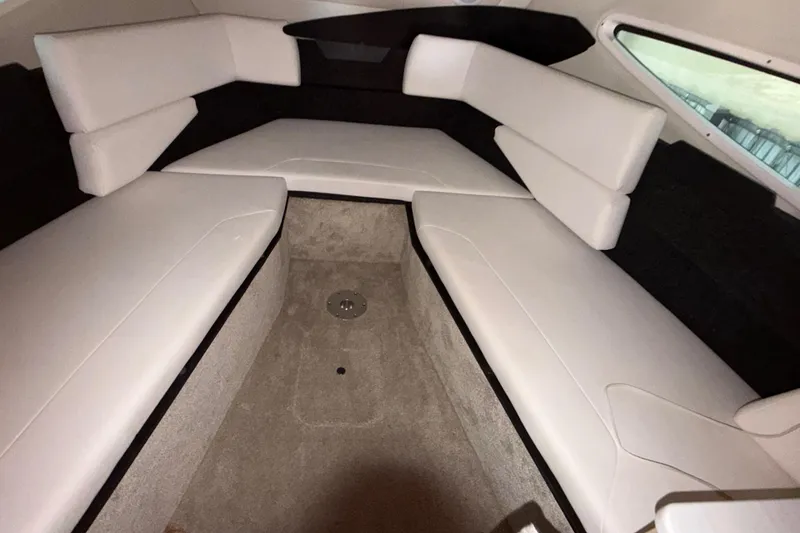 Slide: The Image of 2023 Regal 26 XO boat interior with white cushioned seating and carpeted flooring. - 139