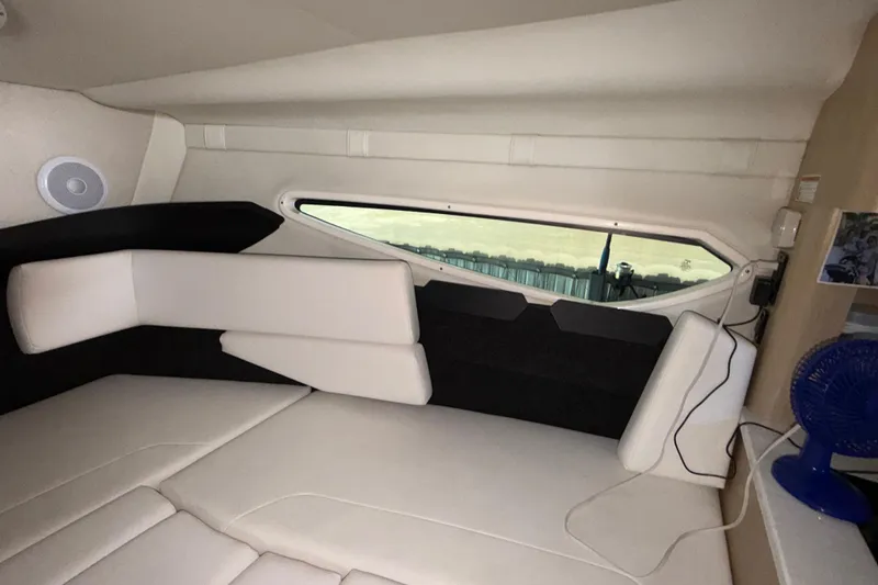 Slide: The Image of Interior cabin of 2023 Regal 26 XO boat with modern seating and window view. - 140