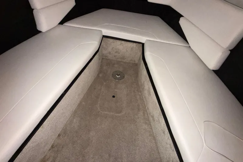 Slide: The Image of Interior seating of 2023 Regal 26 XO boat with white cushions and carpeted floor. - 144