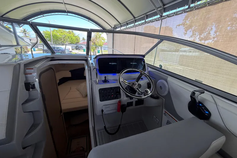 Slide: The Image of Interior view of 2023 Regal 26 XO boat, featuring helm and cabin entrance. - 150