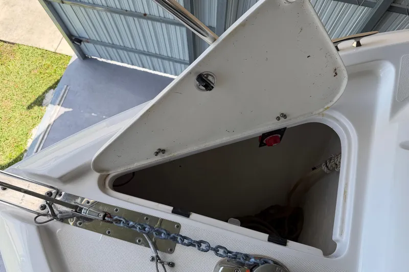 Slide: The Image of Open storage compartment on a 2023 Regal 26 XO boat, showing anchor chain and rope. - 160