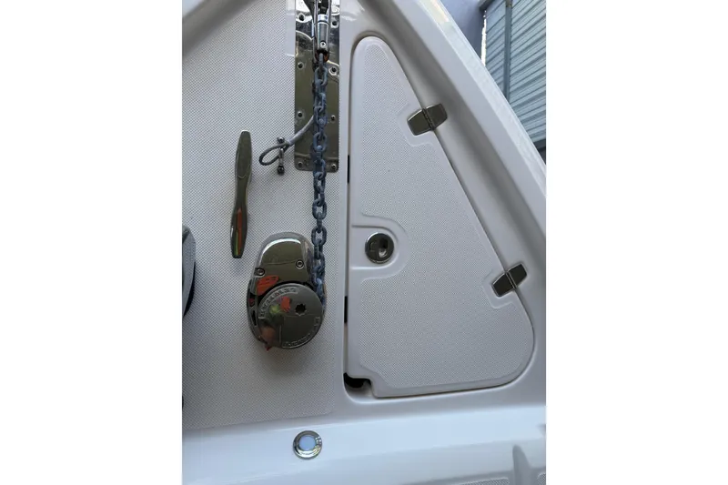 Slide: The Image of 2023 Regal 26 XO boat anchor compartment with chain and latch. - 161