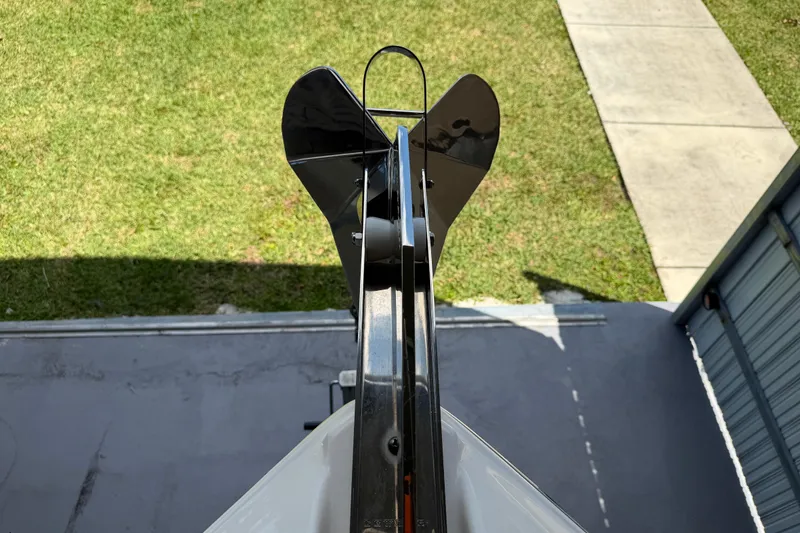 Slide: The Image of Top view of 2023 Regal 26 XO boat anchor, positioned on a grassy area. - 162