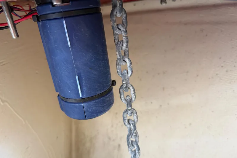 Slide: The Image of Close-up of a blue motor and chain on a 2023 Regal 26 XO boat. - 163