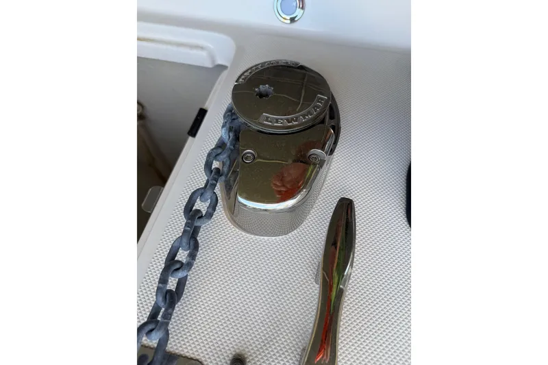 Slide: The Image of Anchor windlass on 2023 Regal 26 XO boat deck with chain detail. - 165