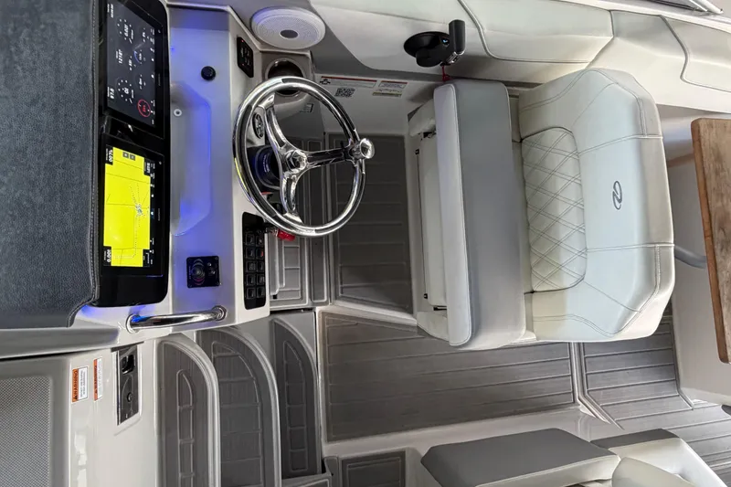 Slide: The Image of 2023 Regal 26 XO boat interior with modern dashboard and steering wheel. - 168