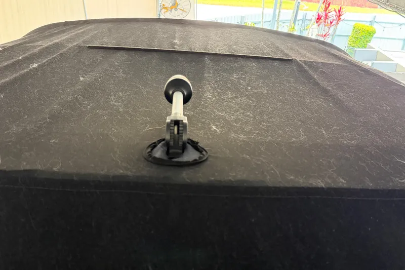 Slide: The Image of 2023 Regal 26 XO boat cover with a securing latch in focus. - 174