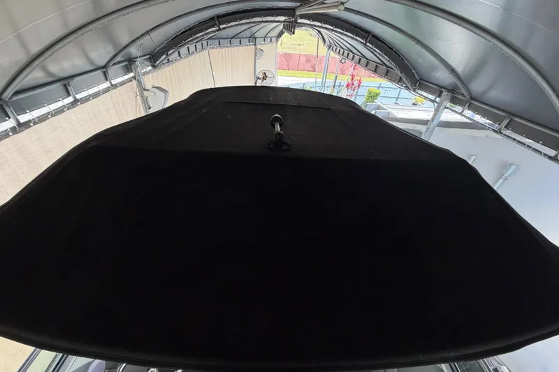 Slide: The Image of 2023 Regal 26 XO boat under a covered dock, viewed from above. - 175