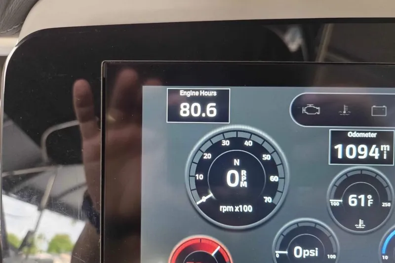 Slide: The Image of Dashboard of 2023 Regal 26 XO showing 80.6 engine hours and 1094 miles. - 24