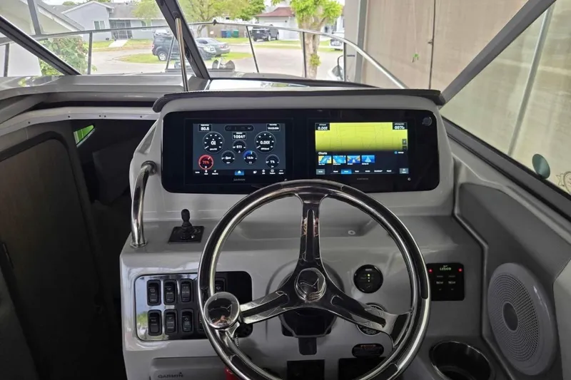 Slide: The Image of 2023 Regal 26 XO boat dashboard with modern controls and navigation screens. - 29