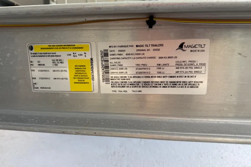 Slide: The Image of Label on Magic Tilt trailer with tire and loading information for Regal 26 XO, 2023 model. - 34