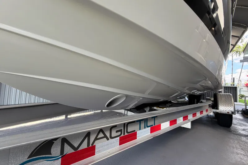 Slide: The Image of 2023 Regal 26 XO boat on Magic Tilt trailer, showcasing sleek hull design. - 35