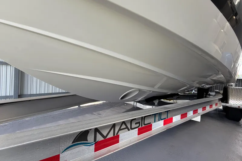 Slide: The Image of 2023 Regal 26 XO boat on Magic Tilt trailer in storage facility. - 36