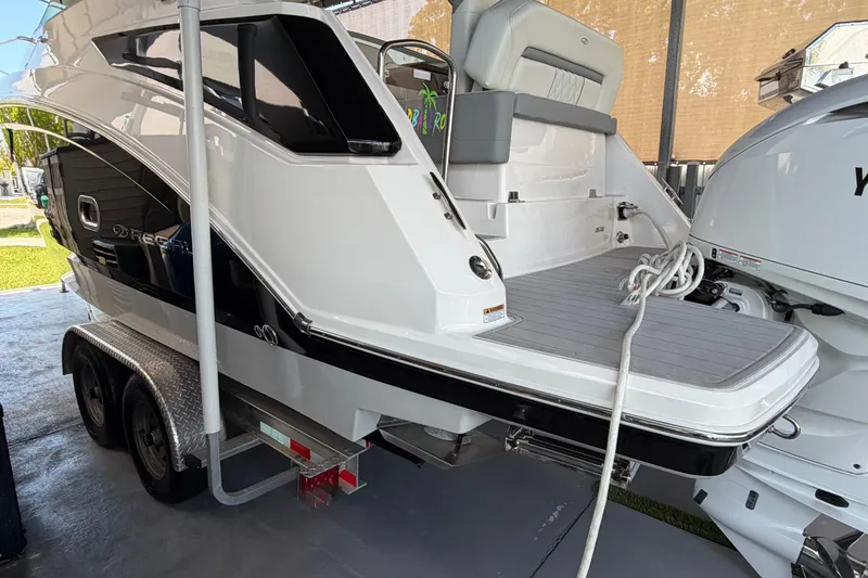 Slide: The Image of 2023 Regal 26 XO boat on trailer, showcasing sleek design and modern features. - 38