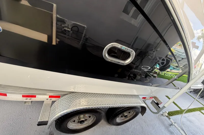 Slide: The Image of 2023 Regal 26 XO boat on trailer, showcasing sleek black exterior and chrome details. - 39