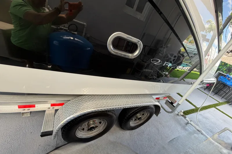 Slide: The Image of 2023 Regal 26 XO boat on trailer, featuring sleek design and reflective surface. - 40