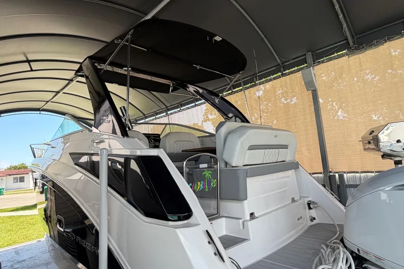 Slide: The Image of 2023 Regal 26 XO boat under a canopy, showcasing sleek design and modern features. - 41