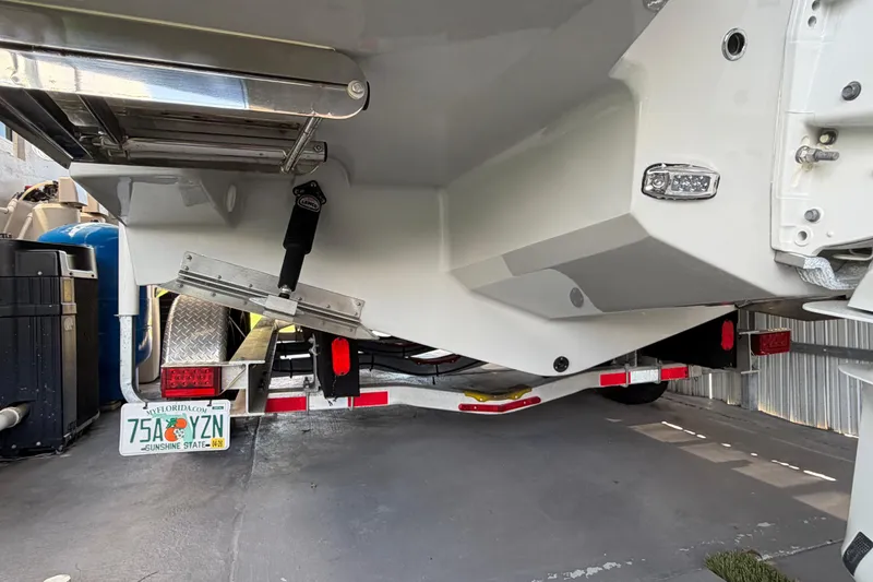 Slide: The Image of 2023 Regal 26 XO boat on trailer, rear view, Florida license plate visible. - 42