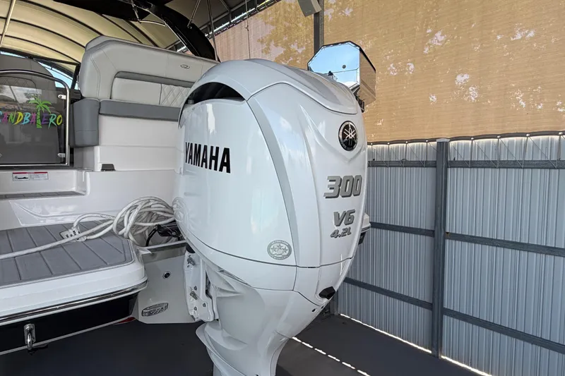 Slide: The Image of 2023 Regal 26 XO boat with Yamaha 300 V6 outboard engine in a covered dock. - 46