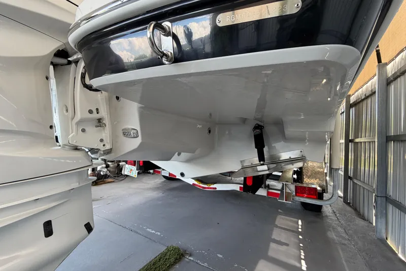 Slide: The Image of 2023 Regal 26 XO boat on trailer, showcasing hull and outboard motor. - 48