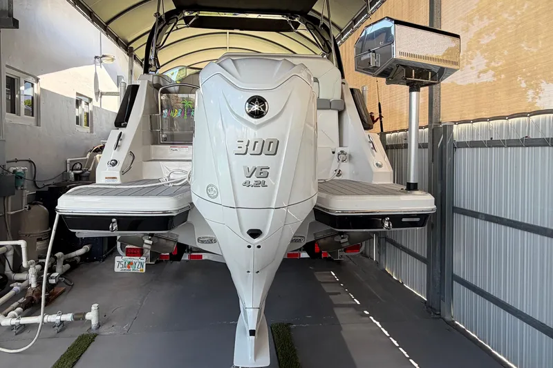 Slide: The Image of 2023 Regal 26 XO boat with Yamaha 300 V6 engine in covered storage. - 50