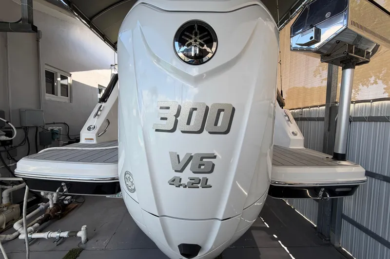 Slide: The Image of 2023 Regal 26 XO boat with 300 V6 4.2L engine in storage. - 51