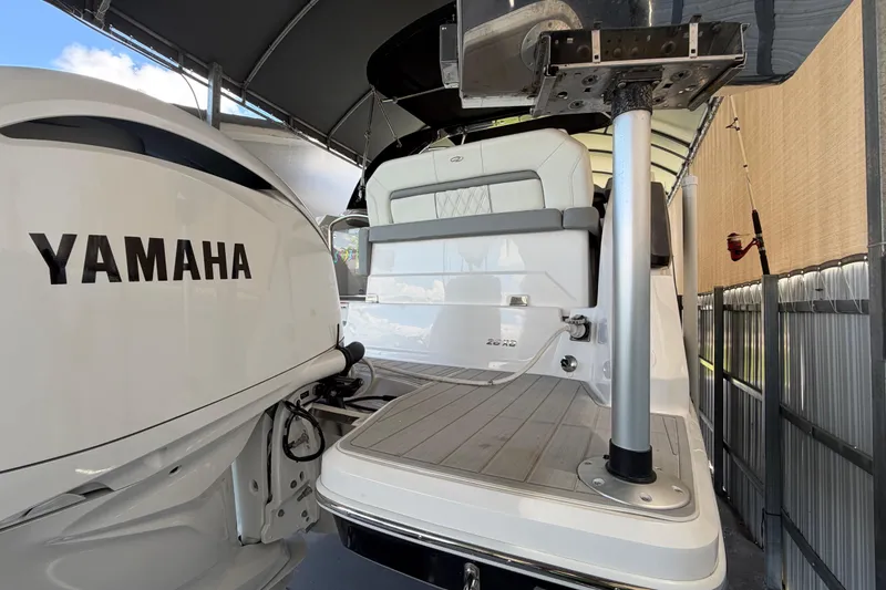 Slide: The Image of 2023 Regal 26 XO boat with Yamaha engine, docked under a canopy. - 53
