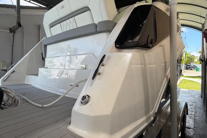 Slide: The Image of 2023 Regal 26 XO boat in storage, showcasing sleek design and modern features. - 55