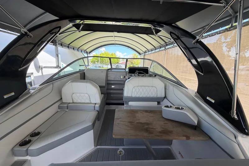 Slide: The Image of 2023 Regal 26 XO boat interior with seating and table under canopy. - 70