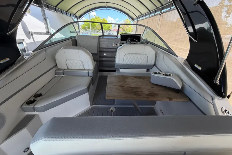 Slide: The Image of 2023 Regal 26 XO boat interior with seating, table, and canopy. - 71