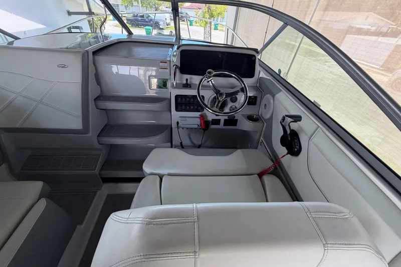 Slide: The Image of 2023 Regal 26 XO boat interior with steering wheel and control panel. - 76