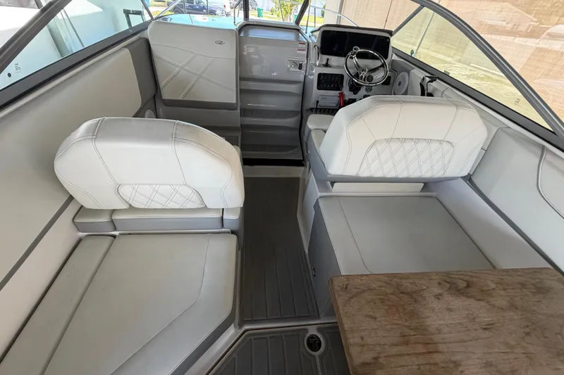 Slide: The Image of Interior of 2023 Regal 26 XO boat with white seating and steering console. - 78
