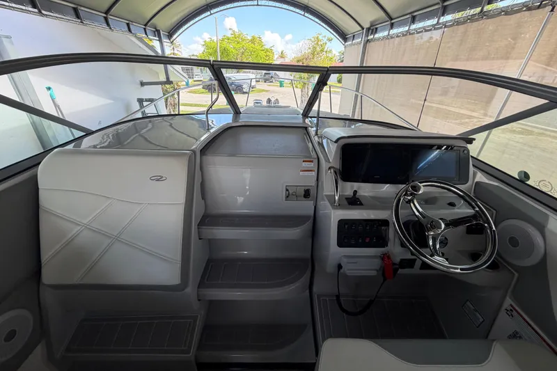 Slide: The Image of 2023 Regal 26 XO boat interior with steering wheel and dashboard controls. - 81