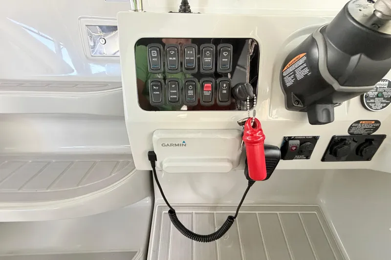 Slide: The Image of Control panel of 2023 Regal 26 XO boat with Garmin device and switches. - 88