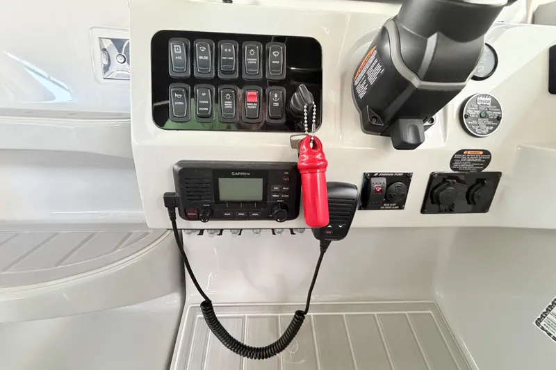 Slide: The Image of Control panel of 2023 Regal 26 XO boat with switches and Garmin device. - 89