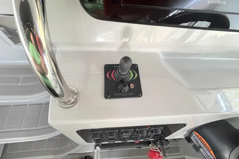 Slide: The Image of Control panel of 2023 Regal 26 XO boat featuring joystick and switches. - 90
