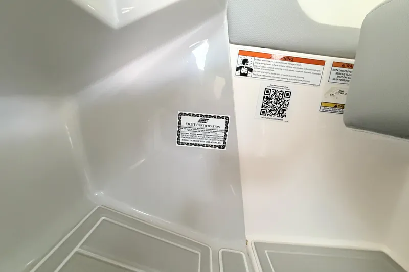Slide: The Image of Interior of 2023 Regal 26 XO boat showing yacht certification and safety warnings. - 91