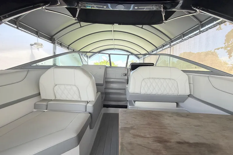 Slide: The Image of Interior of 2023 Regal 26 XO boat with white seating and canopy. - 94
