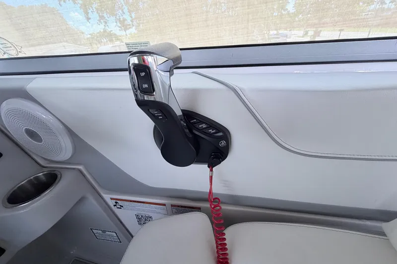 Slide: The Image of 2023 Regal 26 XO boat throttle control with speaker and cup holder. - 96