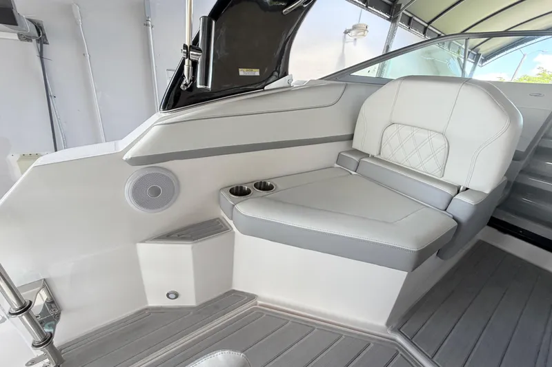 Slide: The Image of 2023 Regal 26 XO boat interior with cushioned seating and cup holders. - 99