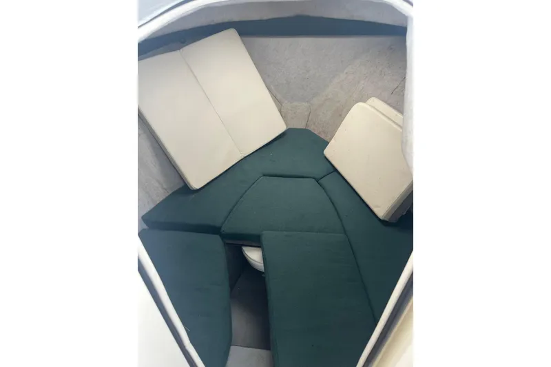 Slide: The Image of 2006 Trophy 2359 Hardtop cabin interior with green and beige cushions. - 14
