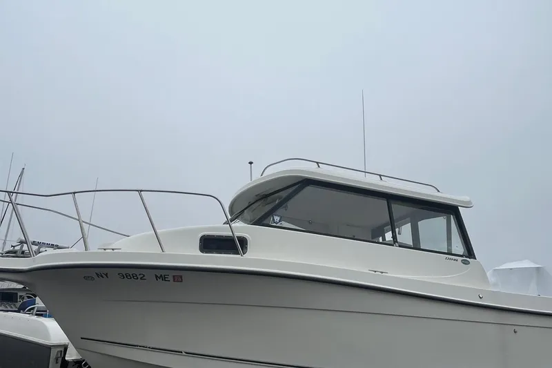 Slide: The Image of 2006 Trophy 2359 Hardtop boat docked on a foggy day. - 18