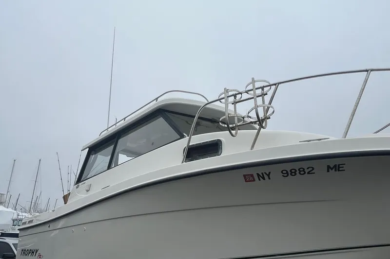 Slide: The Image of 2006 Trophy 2359 Hardtop boat with registration NY 9882 ME, docked on a foggy day. - 19