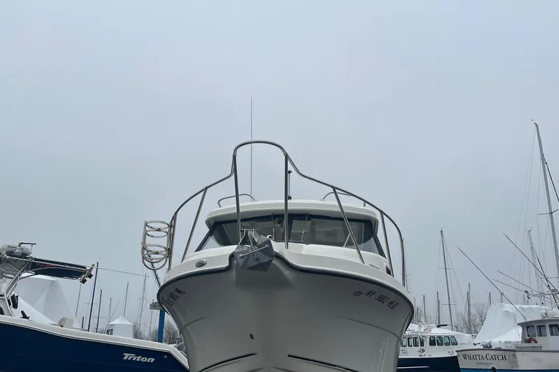Slide: The Image of 2006 Trophy 2359 Hardtop boat docked at marina, overcast sky. - 20