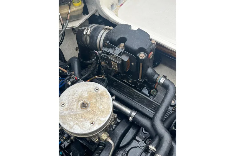 Slide: The Image of Engine compartment of a 2006 Trophy 2359 Hardtop boat, showcasing mechanical components. - 25